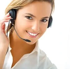 Friendly medical office representative wearing a headset, representing contacting OC MedDerm for confidential consultation, STD evaluation, and appointment scheduling.