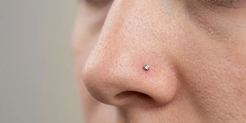 nostril nose piercing stud clean skin healing close up